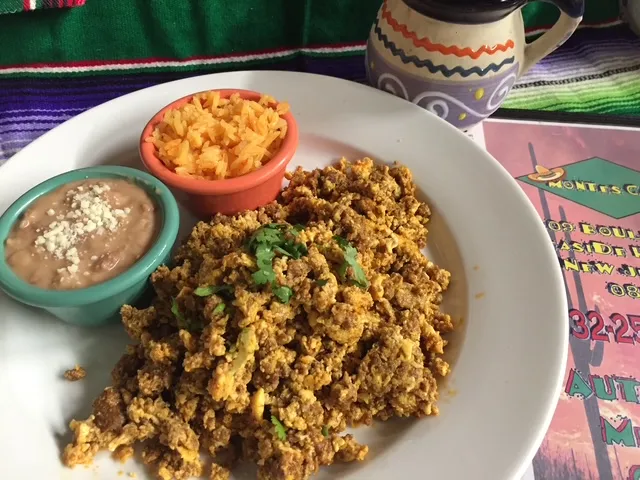 Huevos con chorizo with rice and refried beans