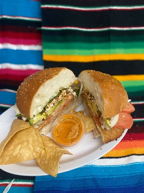 A cemita on a sesame roll, cut in half