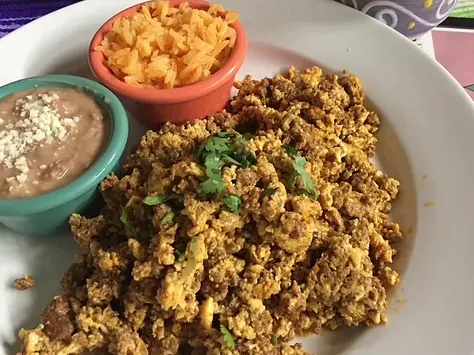 Huevos con chorizo with refried beans and rice