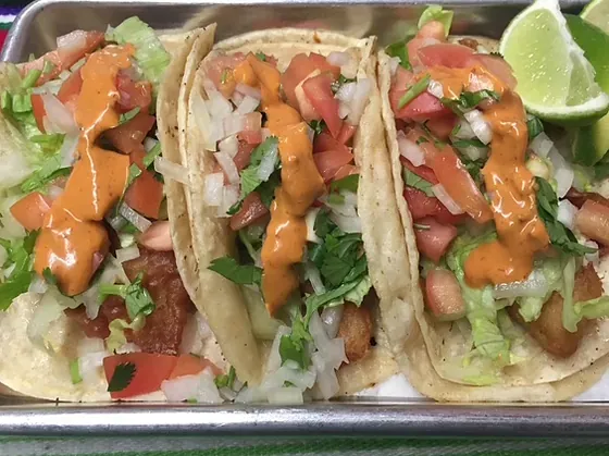 Three soft tacos with pico de gallo, lettuce and a chipotle sauce