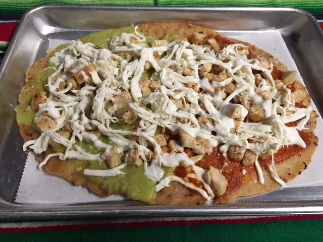 Huarache topped with cream and cheese