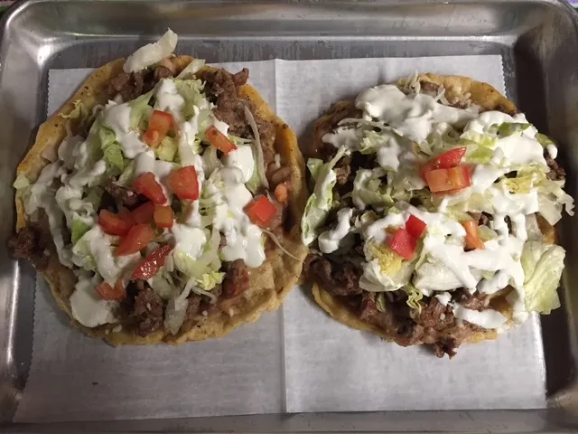 Two sopes topped with lettuce, cream and cheese